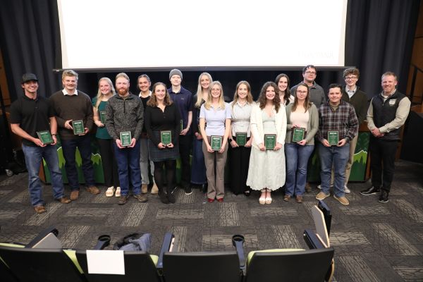 A group photo of students with their award with Chancellor Johnny MacLean