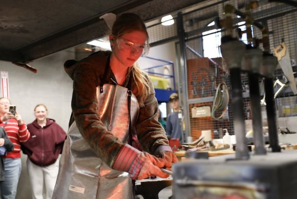 student glowing as she works in metallurgy lab