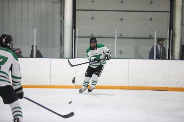 Oredigger hockey players pass the puck