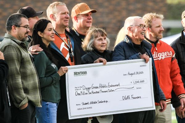 A group poses with a $1.2 million check