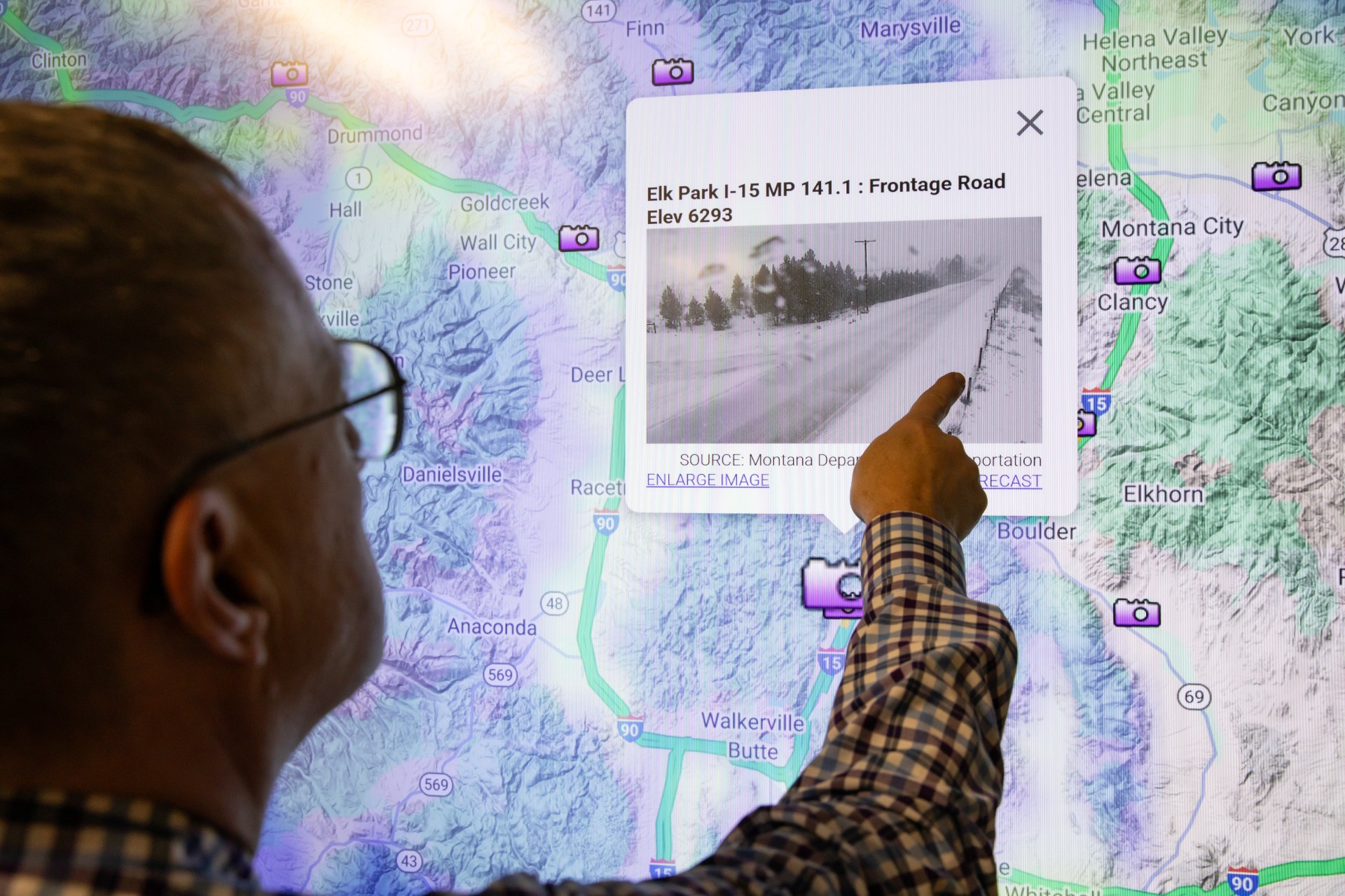 Doug Galarus in front of smartboard with OSS website behind him