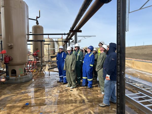 Students look at heater treaters at a rig managed by Continental Resources