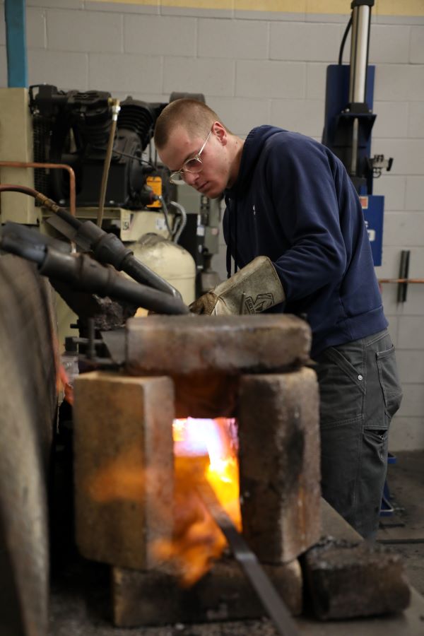 Welding student at the forge