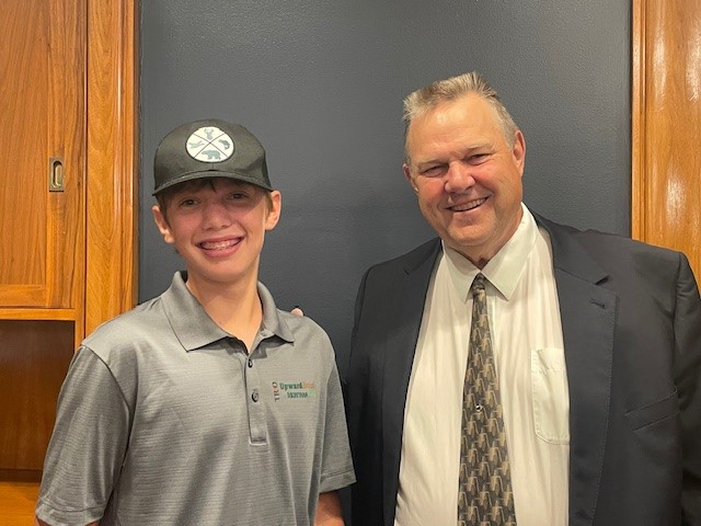 A student poses with Senator Tester